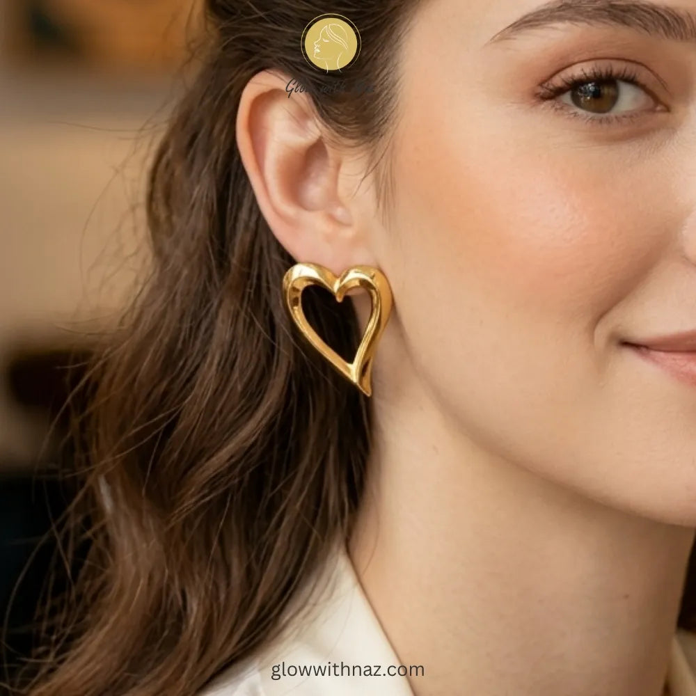 Close-up detail of the smooth, reflective gold surface of the heart studs