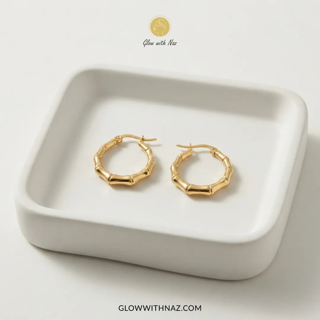 Gold plated stainless steel bamboo bone segment jointed hoop earrings with latch closure by Glow With Naz