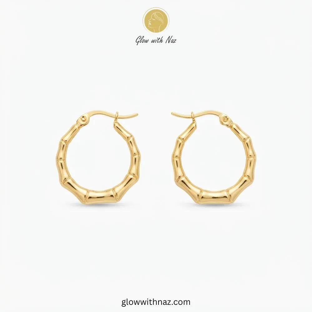 Gold plated stainless steel bamboo bone segment jointed hoop earrings with latch closure by Glow With Naz