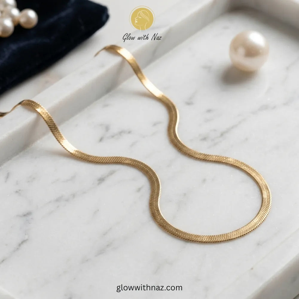 Premium gold herringbone necklace displayed on a luxury jewelry tray