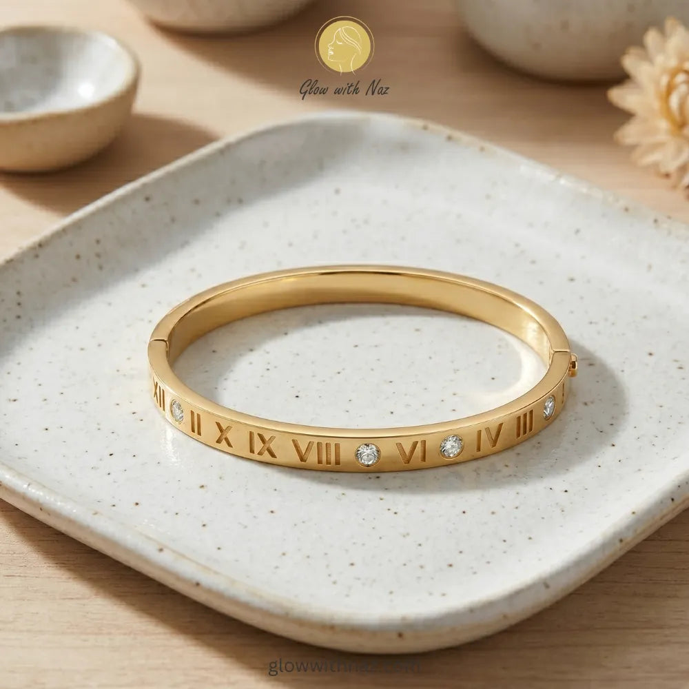 Roman numeral gold bangle stacked with luxury wrist accessories