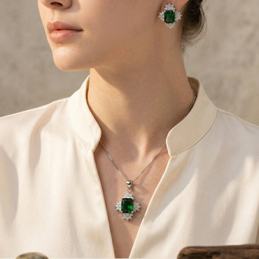 Elegant Sun Flower Style Necklace & Earrings Set - Elegant Sun Flower Style Necklace & Earrings SetJewelryGlow With NazGlow With NazN-N012N-N012silver jewelry set featuring an emerald - cut green crystal pendant necklace and matching stud earrings, both surrounded by a sparkling cubic zirconia floral halo