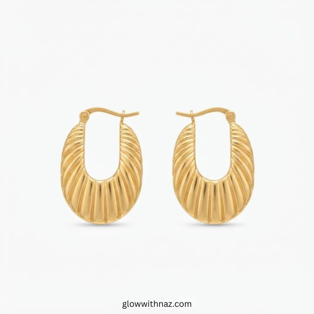 Gold plated stainless steel abstract ribbed oval shell hoop earrings with latch closure by Glow With Naz