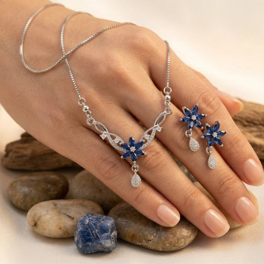Original Zircon Blue Sapphire Necklace & Earrings Set - Original Zircon Blue Sapphire Necklace & Earrings SetJewelryGlow With NazGlow With NazN-N011N-N011silver floral jewelry set featuring navy blue sapphire - colored petals and sparkling diamond - accented teardrops, including a delicate box chain necklace and matching drop earrings.