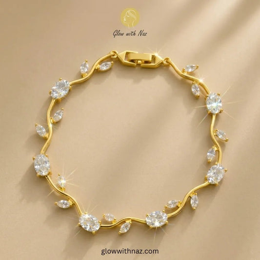 Premium White Tulip Bracelet | Rapunzel Floral Stainless Steel Bracelet - Premium White Tulip Bracelet | Rapunzel Floral Stainless Steel BraceletJewelryGlow With NazGlow With NazTB006AA gold bracelet with clear gemstones arranged along a wavy line, displayed on a beige background with a 'Glow with Naz' watermark. Tulip Rapunzel bracelet, floral tulip bracelet, Rapunzel inspired jewelry, aesthetic tulip bracelet, trendy charm bracelet, stainless steel tulip bracelet, gold plated flower bracelet,