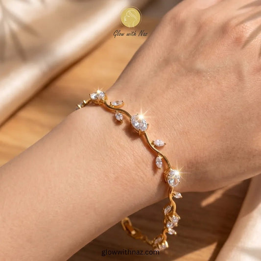 Premium White Tulip Bracelet | Rapunzel Floral Stainless Steel Bracelet - Premium White Tulip Bracelet | Rapunzel Floral Stainless Steel BraceletJewelryGlow With NazGlow With NazTB006AGold bracelet with clear stones on a wrist, brand 'Glow with Naz' visible Tulip Rapunzel bracelet, floral tulip bracelet, Rapunzel inspired jewelry, aesthetic tulip bracelet, trendy charm bracelet, stainless steel tulip bracelet, gold plated flower bracelet, delicate floral wrist accessory, cute aesthetic jewelry,