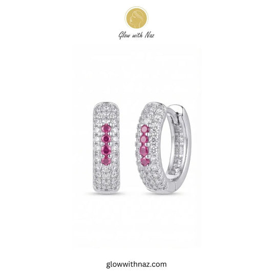 Silver multi row pave zircon huggie hoop earrings featuring 4 pink center accent stones by Glow With Naz