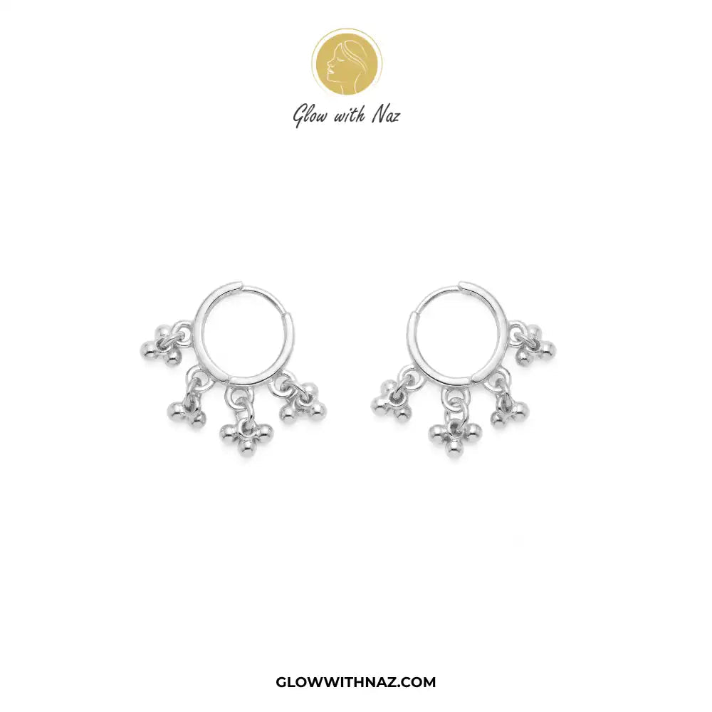 12 mm Anti-Tarnish Silver 3 Drop Separate Hoops Earrings for Women - 12 mm Anti-Tarnish Silver 3 Drop Separate Hoops Earrings for WomenJewelryGlow With NazGlow With NazA pair of silver huggie hoop earrings with dangling floral charms, displayed on a clean white background with the brand logo 'Glow with Naz' at the top and the website 'GLOWWITHNAZ.COM' at the bottom. Silver 3 Drop Separate Hoops, Glow With Naz earrings, stainless steel silver earrings, viral trending earrings, drop huggie hoops, 