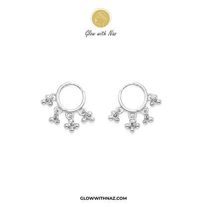 12 mm Anti-Tarnish Silver 3 Drop Separate Hoops Earrings for Women - 12 mm Anti-Tarnish Silver 3 Drop Separate Hoops Earrings for WomenJewelryGlow With NazGlow With NazA pair of silver huggie hoop earrings with dangling floral charms, displayed on a clean white background with the brand logo 'Glow with Naz' at the top and the website 'GLOWWITHNAZ.COM' at the bottom. Silver 3 Drop Separate Hoops, Glow With Naz earrings, stainless steel silver earrings, viral trending earrings, drop huggie hoops, 
