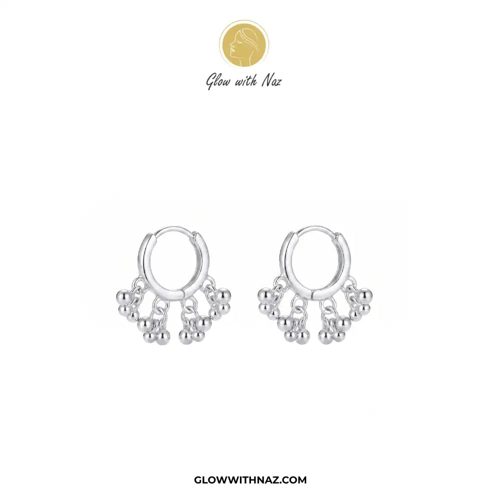 12 mm Silver 3 Attached Silver Drop Hoops for Women - 12 mm Silver 3 Attached Silver Drop Hoops for WomenJewelryGlow With NazGlow With NazE046A pair of silver huggie hoop earrings with dangling beaded fringe, displayed on a clean white background with the brand logo 'Glow with Naz' at the top and the website 'GLOWWITHNAZ.COM' at the bottom. Silver 3 Drop Separate Hoops, Glow With Naz earrings, stainless steel silver earrings, viral trending earrings, drop huggie hoops, silver dangle earrings, ey