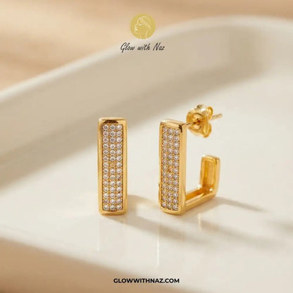 18K Gold Plated Diamond Square Geometric Statement Earrings - 18K Gold Plated Diamond Square Geometric Statement EarringsJewelryGlow With NazGlow With NazE053Close-up shot of the Golden Square Earring showcasing diamond sparkle on a neutral tray