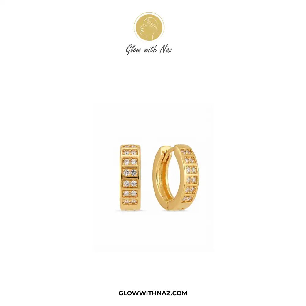 18K Gold Plated Sparkling Small 2-Line Diamond Huggie Earrings for Women - 18K Gold Plated Sparkling Small 2-Line Diamond Huggie Earrings for WomenJewelryGlow With NazGlow With NazE060A pair of gold huggie hoop earrings with rows of small clear stones, shown on a plain white background. The brand name 'Glow with Naz' is displayed at the top with a gold logo, and 'GLOWWITHNAZ.