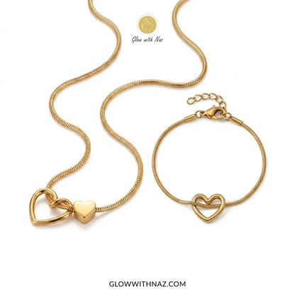 Gold double heart necklace and heart charm bracelet worn together