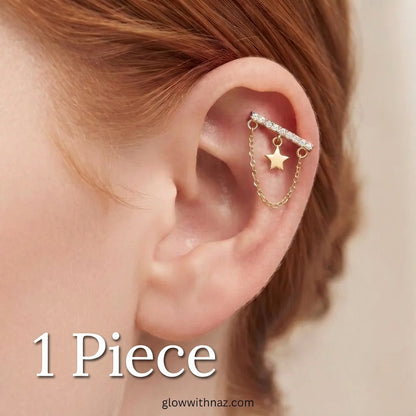 316L Stainless Steel Diamond Bar Helix Jewelry - Trending Star Cartilage Earring - #316L Stainless Steel Diamond Bar Helix Jewelry - Trending Star Cartilage EarringJewelryGlow With NazGlow With NazE074A close-up of a person's ear wearing a gold ear cuff with a barbell, small clear stones, and a dangling star charm.#
