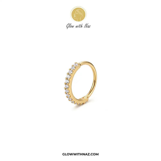 7.5 mm Outer Zircon Stainless Steel Nose Ring - 7.5 mm Outer Zircon Stainless Steel Nose RingJewelryGlow With NazGlow With NazNR005A gold huggie hoop ring with a row of small clear gemstones on one side, displayed on a clean white background with the brand logo 'Glow with Naz' at the top and 'GLOWWITHNAZ.COM' at the bottom. nose ring, front zircon nose ring, stainless steel nose ring, zircon nose ring, gold nose ring, silver nose ring, hoop nose ring, septum ring, cartilage earring, helix pierci