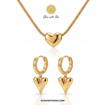 Gold heart-shaped necklace and earrings on a white background with 'Glow with Naz' branding. Puffy Heart Gold Pendant Necklace stainless steel necklace, pendant necklace, necklace set, locket set, simple necklace, pendant set, pendant, chain necklace, diamond pendant, diamond necklace, locket necklace, neck chain, girls locket, heart locket, pendant for girls, necklace for girls, heart necklace, locket for girls, diamond locket, pendant necklace for girls, heart chain locket, stainless steel necklace, doubl