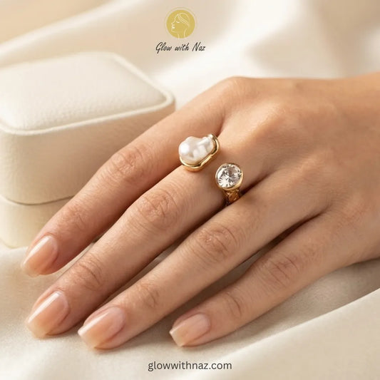 A luxury gold ring featuring a unique baroque pearl and sparkling moissanite, open-band design.