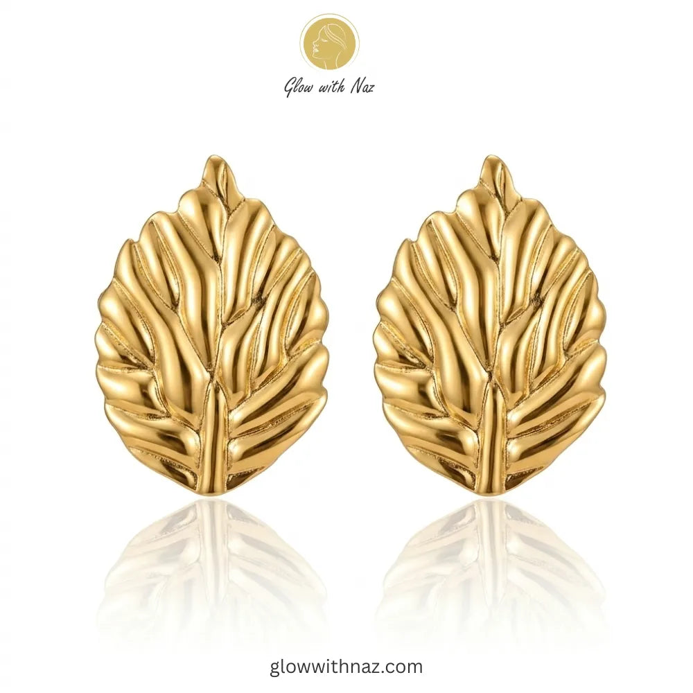 Close-up detail of the intricate, polished texture of the leaf stud earrings