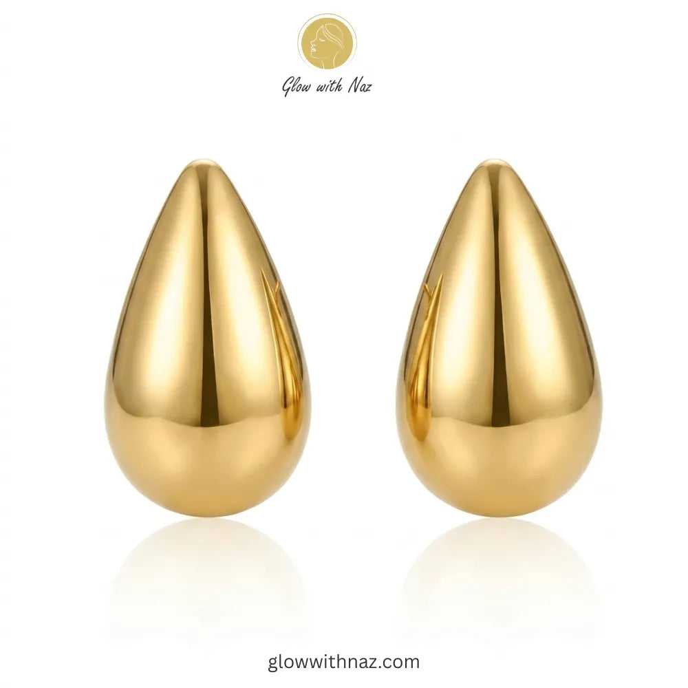 Close-up detail of the smooth, reflective surface of the teardrop stud earrings