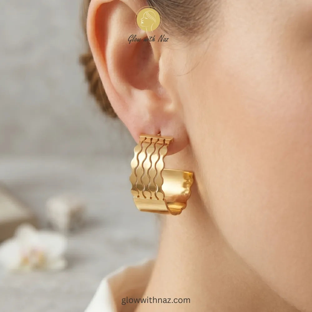Close-up detail showing the intricate layered wave pattern and gold finish