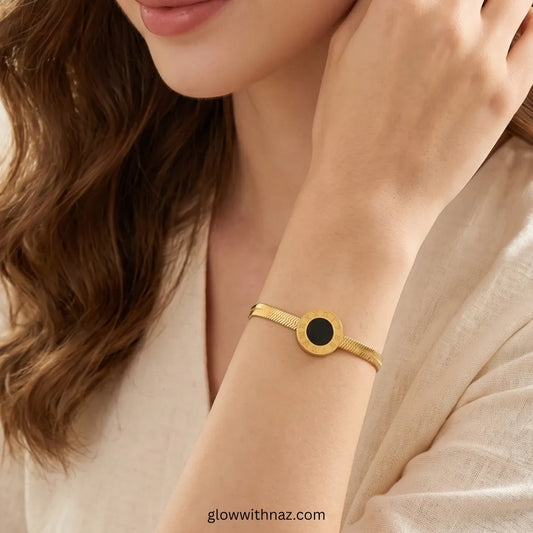 Close-up of Roman numeral charm and herringbone texture