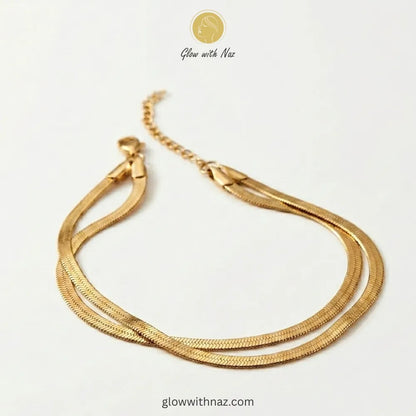 Close-up of herringbone chain texture and clasp detail