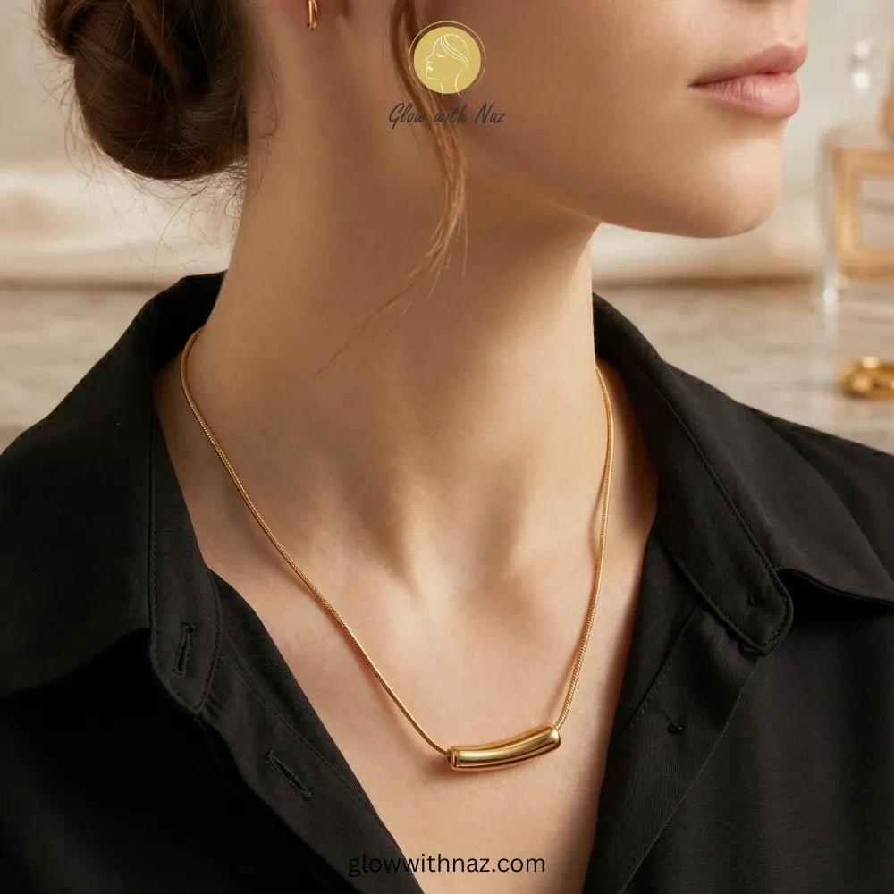Close-up of smooth gold tube bar pendant texture
