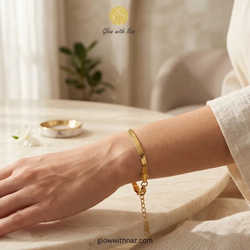 Close-up shot of gold herringbone bracelet clasp and texture details
