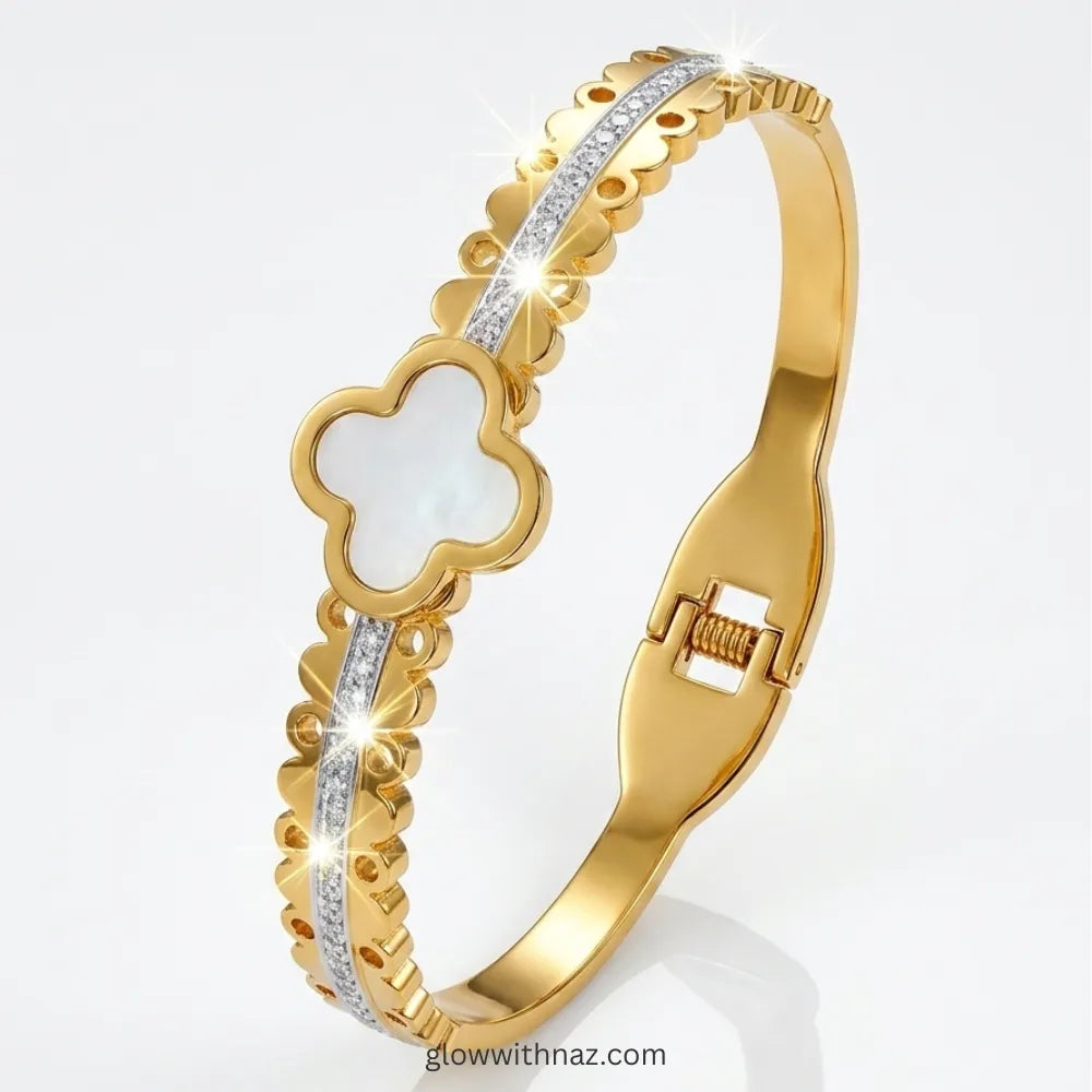 Clover motif gold bangle stacked with luxury wrist accessories