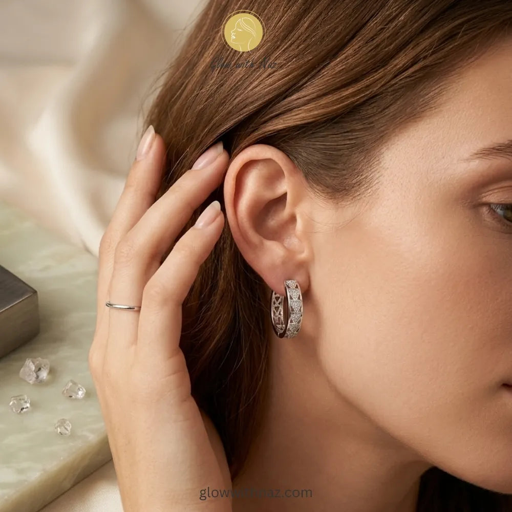 Detailed side view of high-shine silver textured hoop earrings