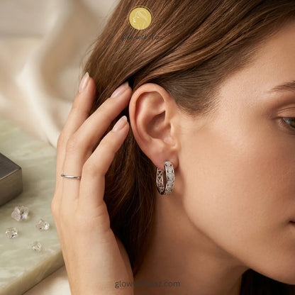 Detailed side view of high-shine silver textured hoop earrings