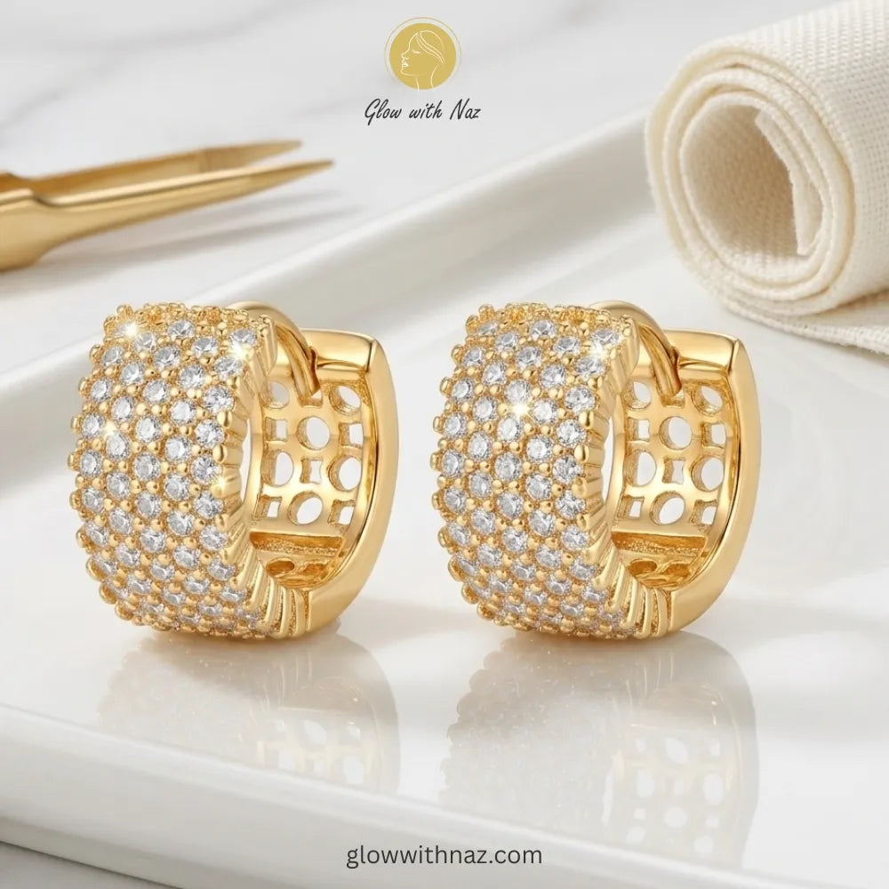 Detailed side view showing the crystal density and gold finish of the hoops