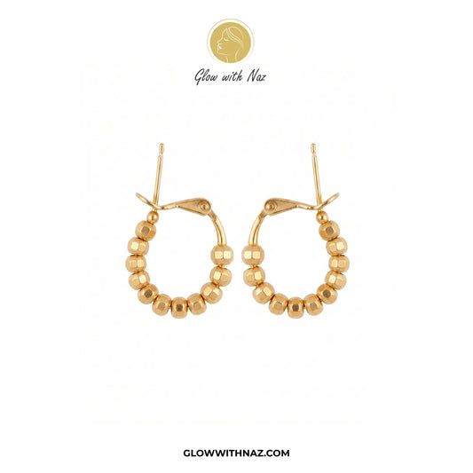 A pair of gold hoop earrings with a beaded outer rim, shown on a plain white background with Glow with Naz branding above and the website at the bottom. studs earrings, small earrings, girls earrings, simple earrings, earrings for girls, black earrings, earrings, ear rings, earrings tops, stud earrings, tops earrings, aesthetic earrings, hoop earrings, drop earrings, diamond earrings, pink earrings, green earrings, ear ring, earrings for women, flower earrings, golden earrings, bali earrings, ear jewellery,