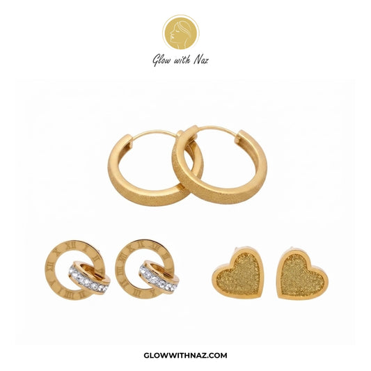 Gold-toned jewelry set on a white background, including two large hoop earrings, two smaller hoop earrings with a row of clear stones, and two textured heart-shaped stud earrings. The brand name 'Glow with Naz' is visible at the top, and 'GLOWWITHNAZ. studs earrings, small earrings, girls earrings, simple earrings, earrings for girls, black earrings, earrings, ear rings, earrings tops, stud earrings, tops earrings, aesthetic earrings, hoop earrings, drop earrings, diamond earrings, pink earrings, green earr