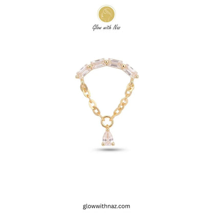 A gold chain bracelet featuring a curved row of clear teardrop-shaped crystals and a dangling clear crystal pendant, shown on a white background with the brand name Glow with Naz.