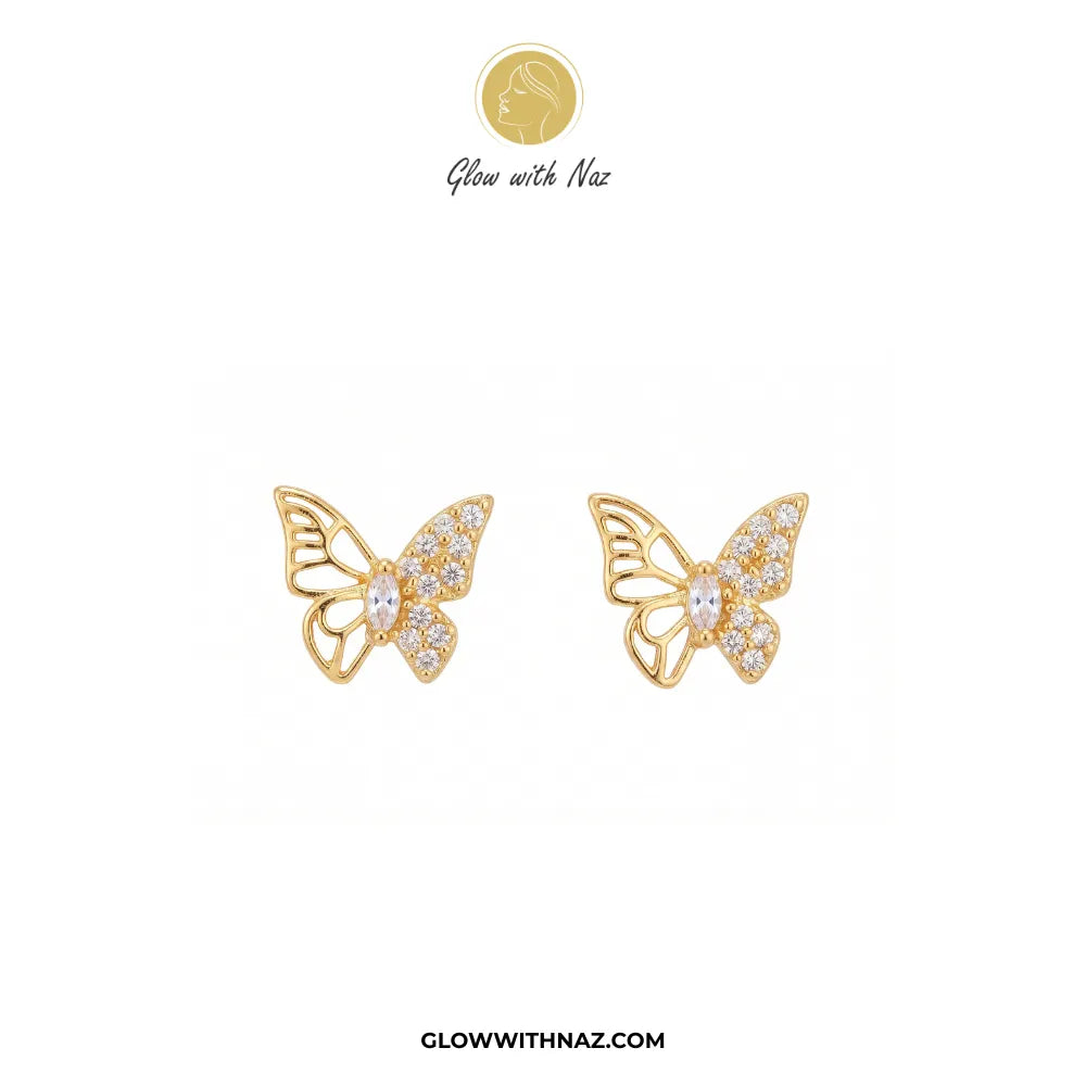 A pair of gold butterfly stud earrings embellished with clear pavé stones, displayed on a clean white background with the brand logo 'Glow with Naz' at the top and the website 'GLOWWITHNAZ.COM' at the bottom.