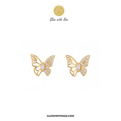 A pair of gold butterfly stud earrings embellished with clear pavé stones, displayed on a clean white background with the brand logo 'Glow with Naz' at the top and the website 'GLOWWITHNAZ.COM' at the bottom.