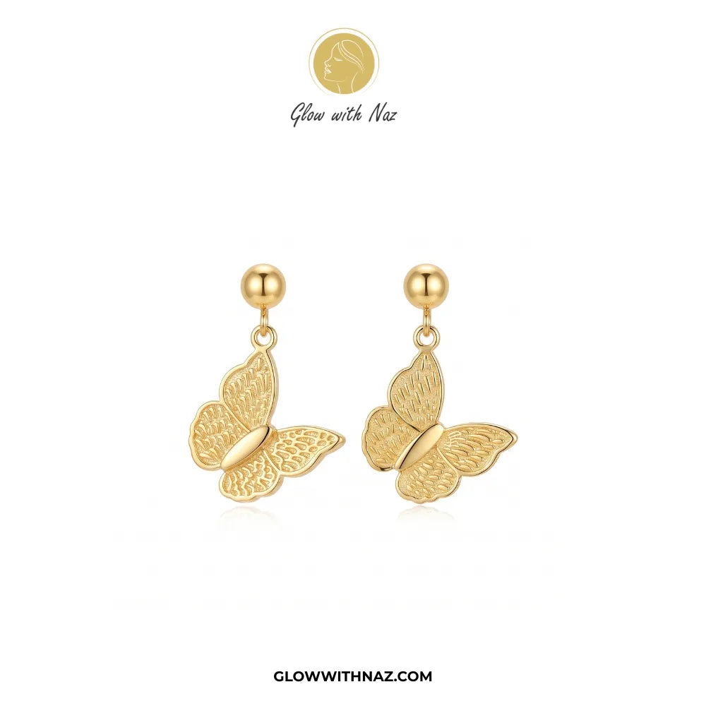 A pair of gold butterfly drop earrings with textured wings and spherical studs, shown on a white background with the brand name Glow with Naz at the top.