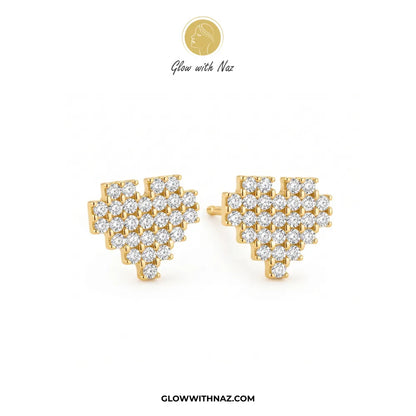 A pair of gold heart-shaped stud earrings paved with clear cubic zirconia stones, displayed on a clean white background with the brand logo 'Glow with Naz' at the top and website URL at the bottom.