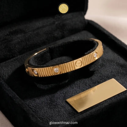 Elegant textured gold bangle with stone accents by Glow with Naz