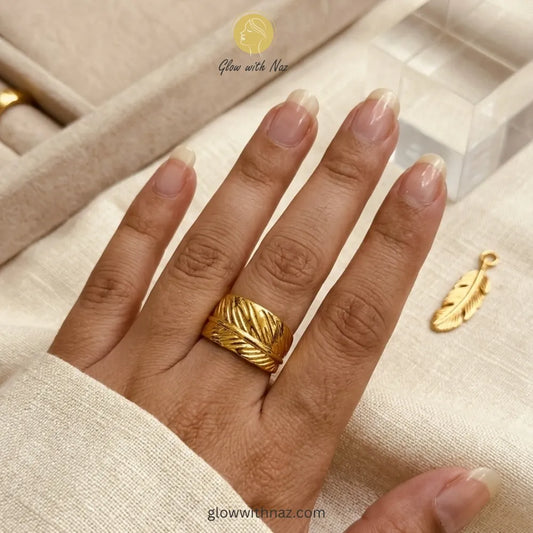 A stylish, free-size gold ring with a detailed feather wrap pattern, crafted from premium stainless steel.