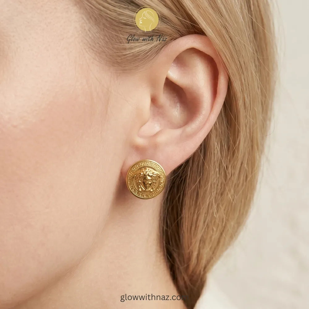 Front view of bold gold portrait stud earrings for formal or high-fashion looks