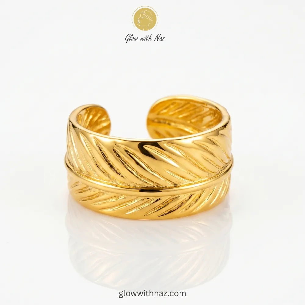 Gold feather wrap wide cuff adjustable free size ring in 18K gold plated stainless steel, nature inspired anti-tarnish ring available online in Pakistan by Glow with Naz