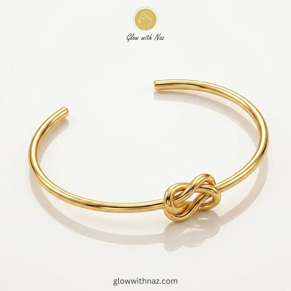 Gold knot cuff stacked with luxury wrist accessories