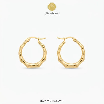 Gold plated stainless steel bamboo bone segment jointed hoop earrings with latch closure by Glow With Naz
