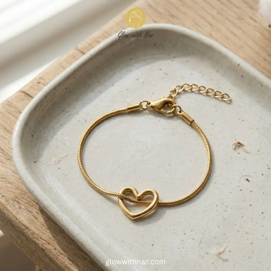 Heart charm bracelet stacked with luxury wrist accessories