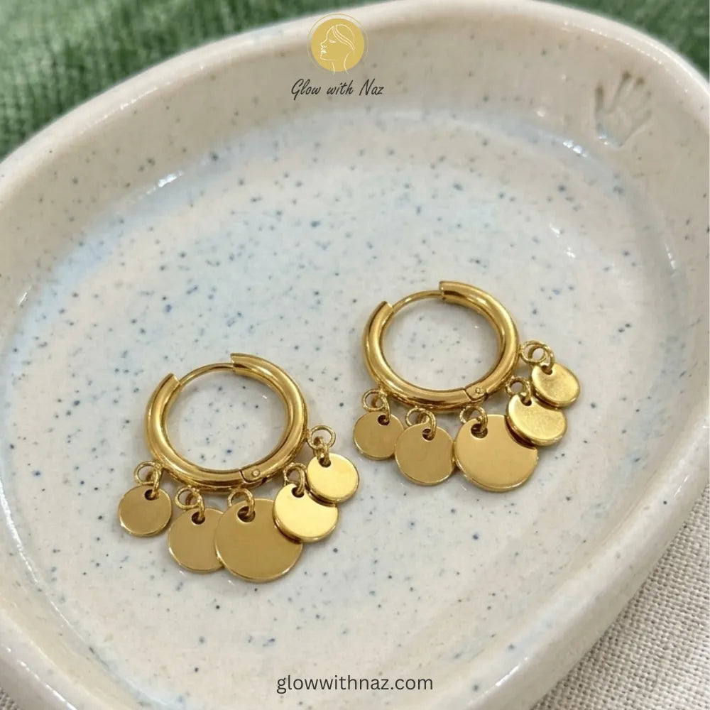 Lifestyle shot of modern coin charm hoop earrings for a stylish statement look