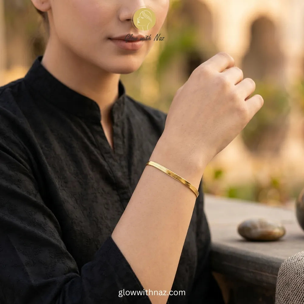 Minimalist gold herringbone bracelet worn for daily luxury styling