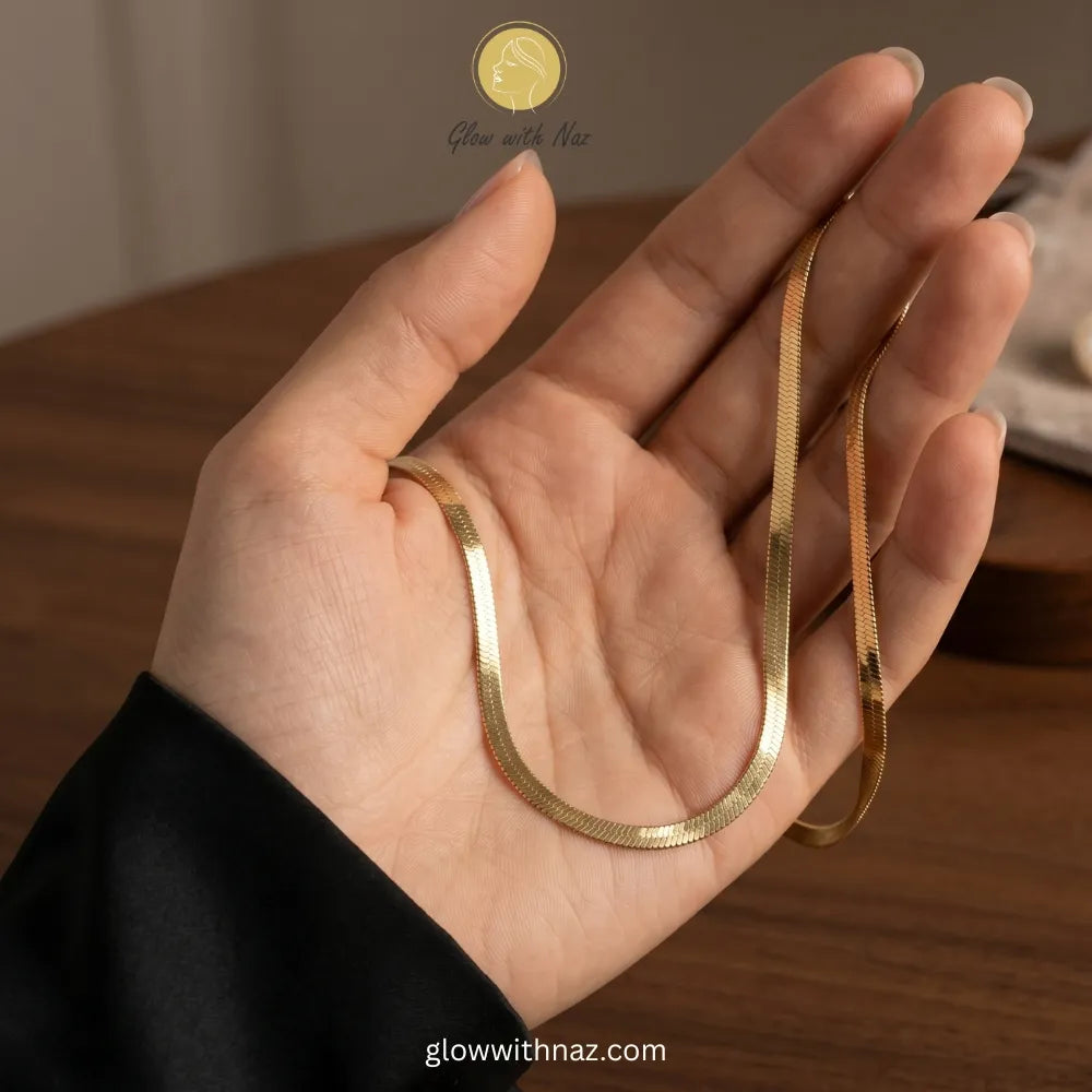 Minimalist gold herringbone necklace worn for daily luxury styling