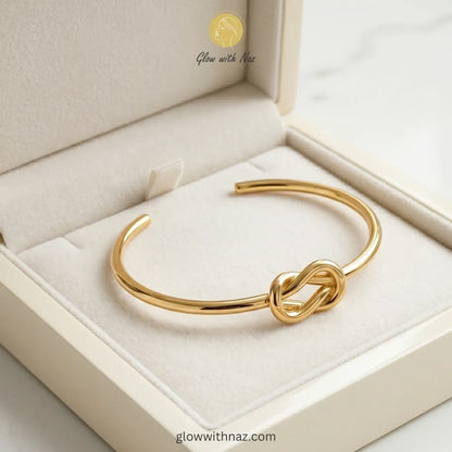 Minimalist gold knot cuff styled for everyday luxury